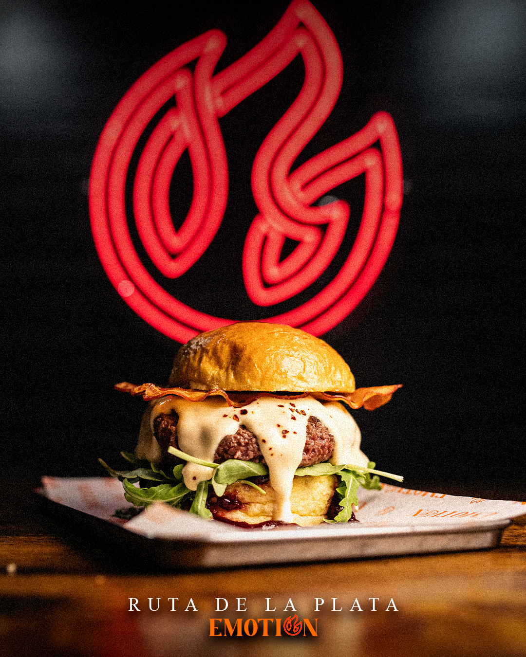 Hamburguesa Ruta de la Plata de Emotion Burger bajo el neón de la marca
